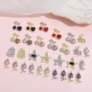 Detailed close-up of colorful Y2K cherry, rabbit, and star alloy pendants on pink silk