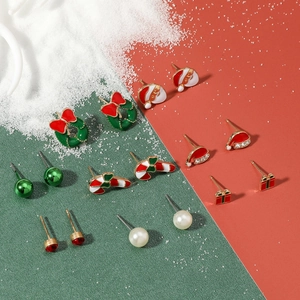 Flat lay of Christmas earring set featuring Santa, reindeer, and candy cane designs