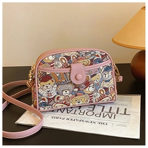 Detail of pink canvas crossbody bag with cartoon bear jacquard and leather piping