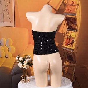 Macro shot of black sequin crop top back details and metallic embroidery craftsmanship