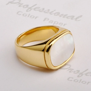 Macro shot of gold square signet ring with a white mother of pearl inlay detail