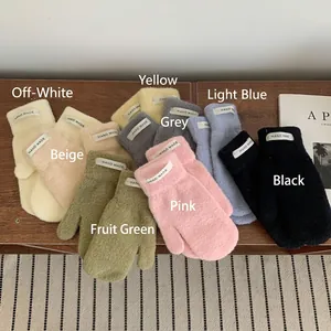Close-up of fluffy knitted gloves in 8 candy colors with Hand Made woven labels