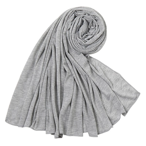 Detailed view of grey jersey fabric texture and soft drape on a minimalist long scarf