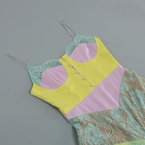 Detail of white dress with yellow lace trim, purple accents and rhinestone straps