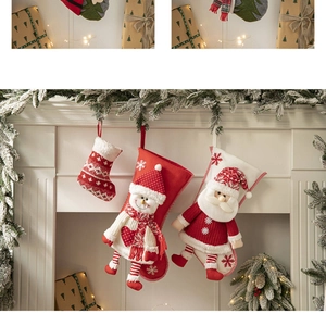 Detailed view of red knitted Christmas stockings with Santa and snowman on fireplace