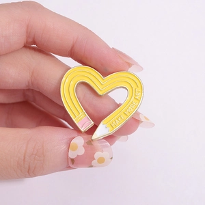 Creative heart-shaped pencil enamel pin with Make More Art text in yellow finish