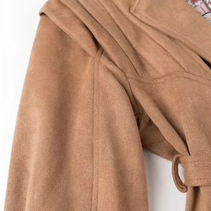 Detail view of brown faux suede biker jacket shoulder with strap and printed lining