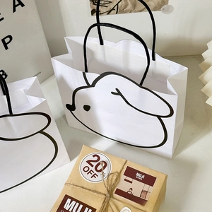 Detail of white gift bag with black bunny doodle design and soft cotton handles