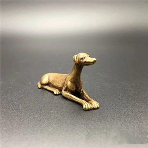 Vintage brass dog figurine in a lying pose for home desktop and tea pet decoration