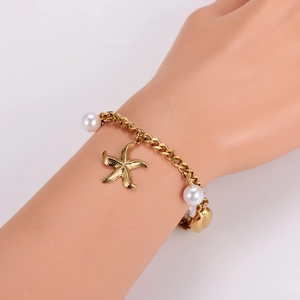 Gold stainless steel bracelet with starfish charms and white pearls for women