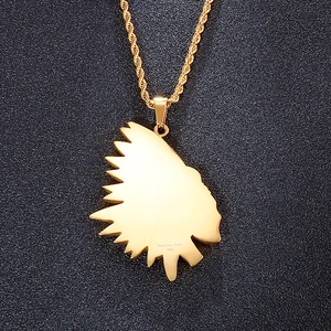 Macro shot of 316L stainless steel engraving on gold Indian profile pendant