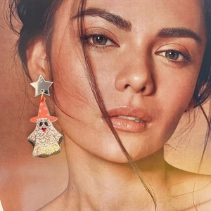 Detailed view of Halloween ghost earrings with red hat and glitter on female model