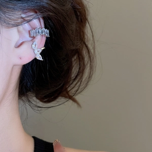 Detailed view of silver ear cuff set with rectangular and butterfly zircon stones
