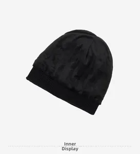 Detail view of the thick fleece lining and ribbed edge on a men's black knit beanie