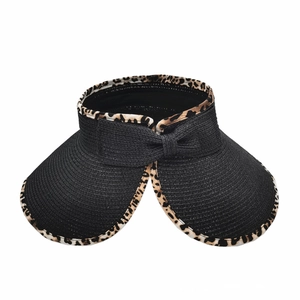 Detail of black straw visor hat featuring leopard print edge and back bow decoration