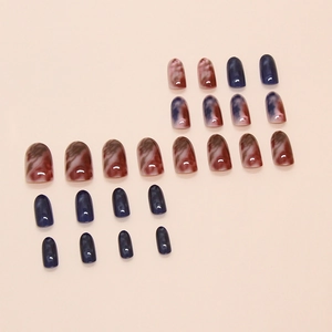Tie-dye and solid color press-on nail set featuring blue and marble texture designs