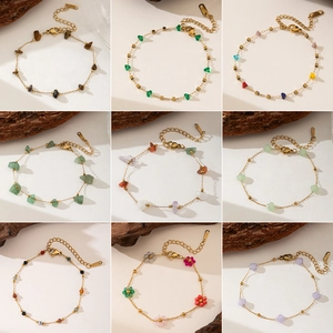 Macro view of assorted colorful natural stone beads and gold stainless steel jewelry