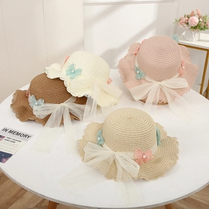 Children's straw sun hats with lace trim and large mesh bows in various colors