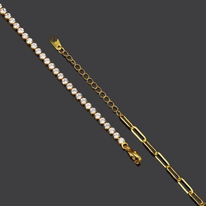 Detail of gold paperclip and tennis chain bracelet featuring white cubic zirconia accents
