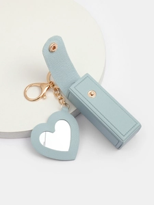 Detail of light blue leather lipstick pouch with heart mirror and metal keyring hanger