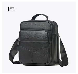 Side view of a black pebble leather crossbody bag with multiple zippers and handle