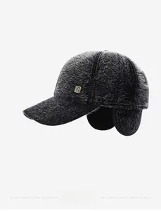 Detail of dark grey winter baseball cap with plush faux fur texture and ear flaps