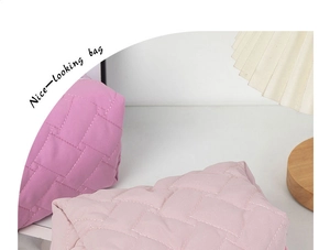Detail of quilted weave texture on purple and pink cosmetic bags with soft grid pattern