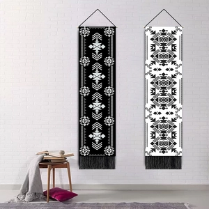 Bohemian butterfly and moon tapestries with fringe hanging on white brick wall