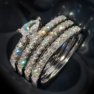Polished 925 sterling silver multilayer ring set featuring a pear-cut stone and pavé accents