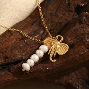 Retro 18K gold plated elephant pendant necklace with white pearls on rustic wood background