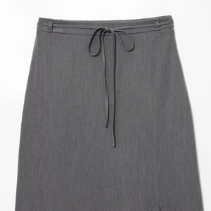 Fashionable grey straight skirt for women featuring adjustable waist tie and textured fabric