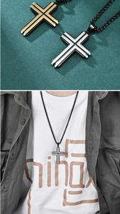 Detail of two-tone stainless steel cross pendants in gold, silver and black finish