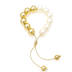 Detail of adjustable pearl and gold bead bracelet with sliding clasp and fine metal chain