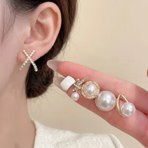 Elegant pearl and rhinestone stud earring set with gold geometric design on model