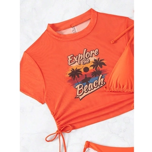 Macro shot of orange mesh bikini set with Explore the Beach print and drawstring detail
