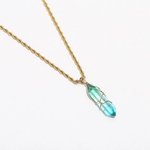 Detail of bohemian turquoise crystal pendant with golden twisted rope chain necklace