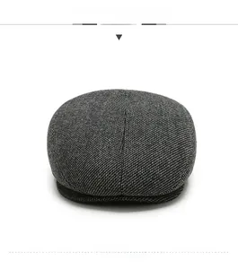 Detailed front view showing the dark grey textured wool blend fabric of the men's flat cap