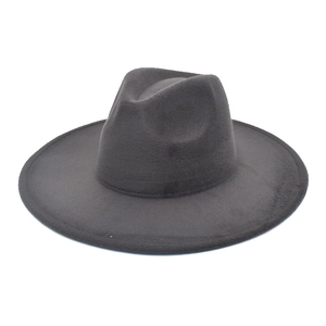 Detail of a dark gray wide brim wool fedora hat with classic indented gentleman crown