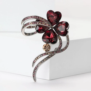 Elegant silver four-leaf clover brooch with burgundy crystals and pink rhinestones