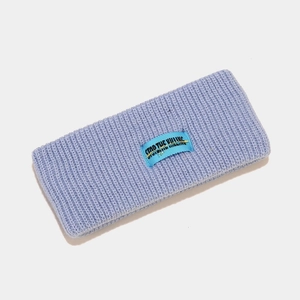 Detail of lavender ribbed knit headband featuring a blue woven 'STOP THE KILLING' label