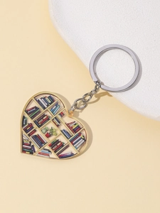 Detailed heart-shaped keychain with miniature bookshelf scene and colorful books