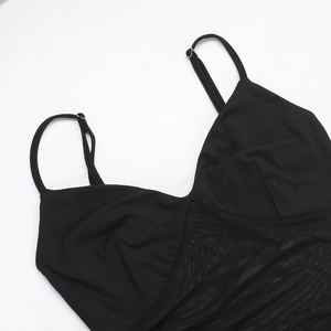 Detail of adjustable spaghetti straps and mesh stitching on a slim fit black dress