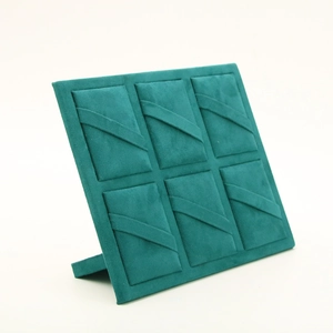 Deep green velvet jewelry display board with six slots for hairpins and necklaces