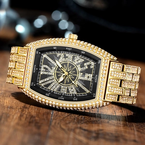 Detailed view of luxury gold tonneau watch with iced-out diamonds and compass dial design