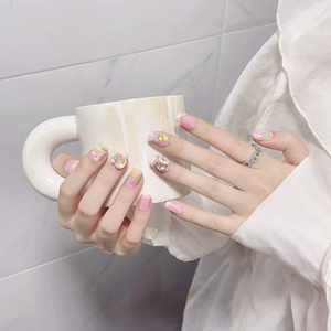 Pink handmade press-on nails with floral patterns, 3D pearls and a silver chain ring