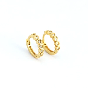 Golden heart-shaped hoop earrings with sparkling inlaid crystals in a minimalist style