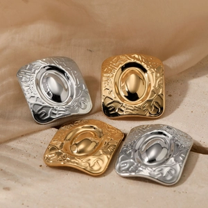 Irregular hammered square metal earrings in gold and silver finish with textured relief