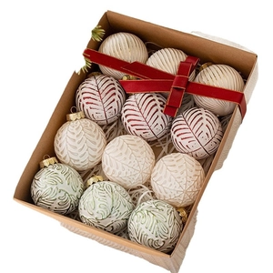 Set of 12 white Christmas tree ornaments with red and green patterns in a gift box