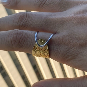 Two-tone 18k gold and silver stainless steel open ring with hammered texture on hand