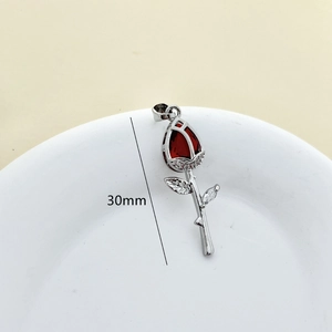 Detail showing a 30mm silver rose pendant with red petals and inlaid crystals